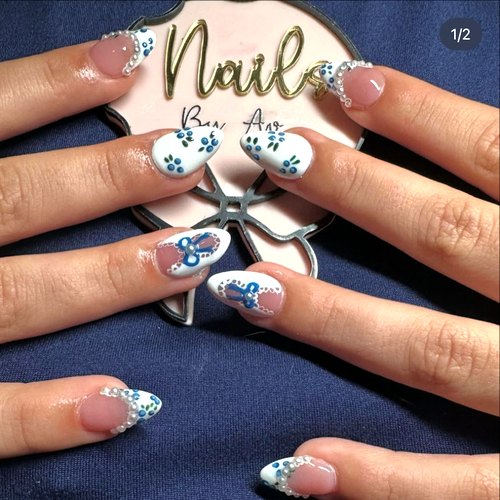 Nail art by Ava held over her pink and black bow sign