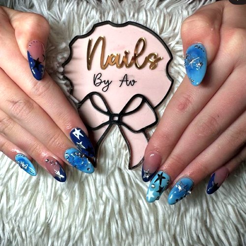 Blue nail art by Ava with her bow sign
