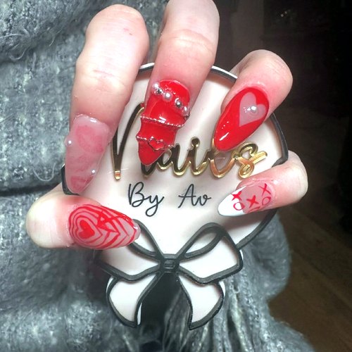 Red and white nail art by Ava