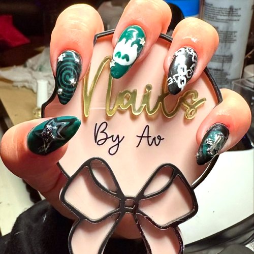 Green and pink nail art by Ava with her bow sign